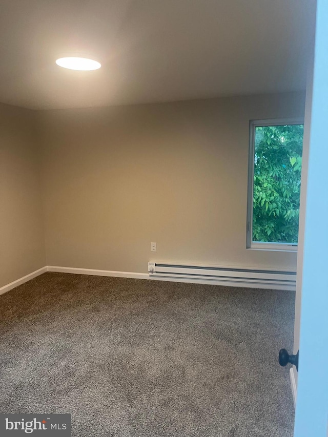 carpeted empty room with baseboard heating