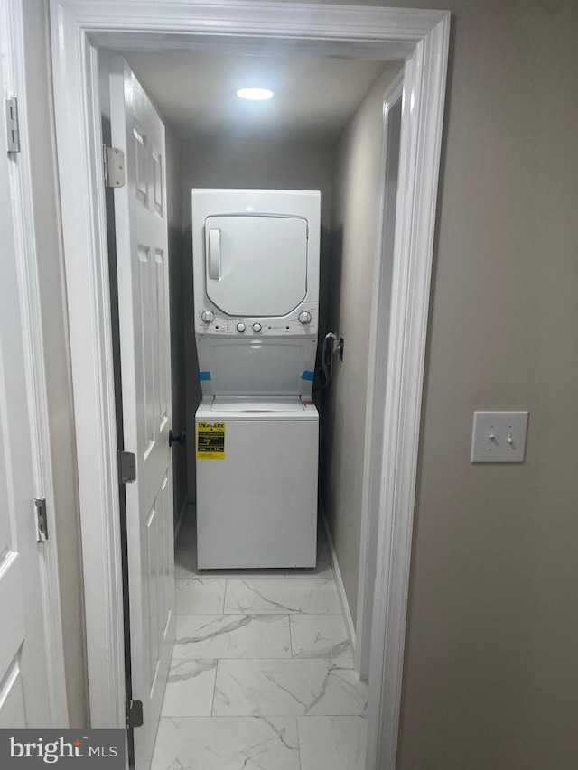 laundry area featuring stacked washer / dryer