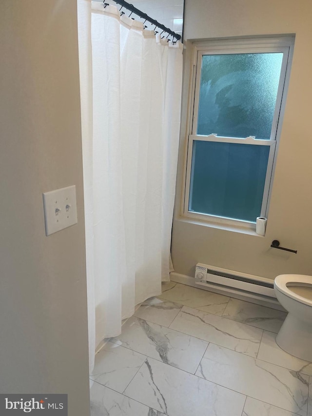 bathroom with toilet, a shower with curtain, and baseboard heating