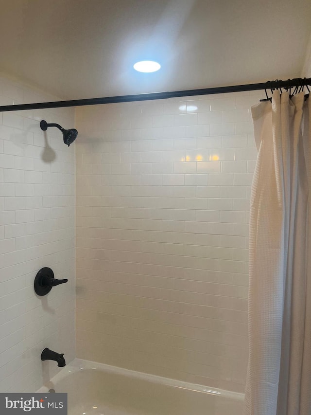 bathroom with shower / tub combo with curtain