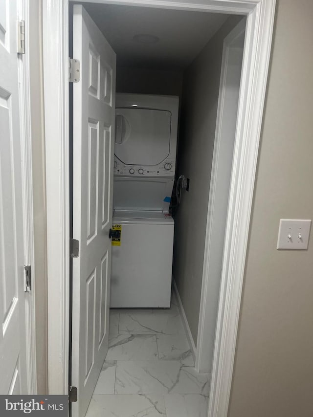 washroom with stacked washer / drying machine