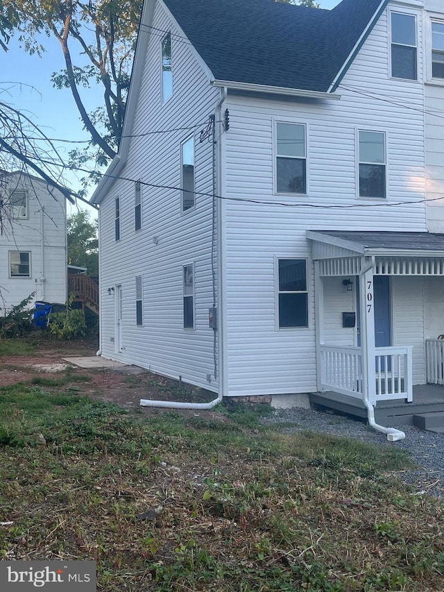 rear view of house featuring a porch