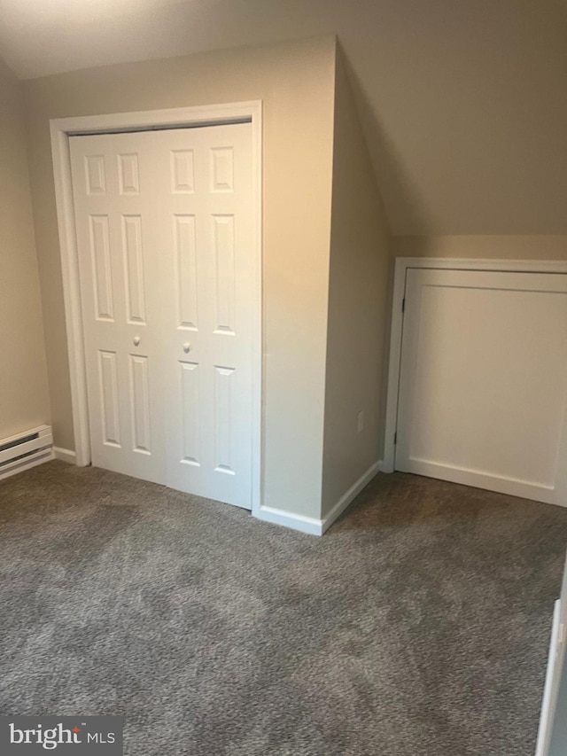 additional living space featuring lofted ceiling and dark carpet