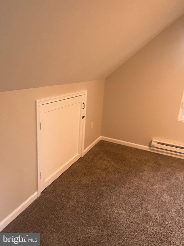 additional living space with baseboard heating, vaulted ceiling, and carpet floors