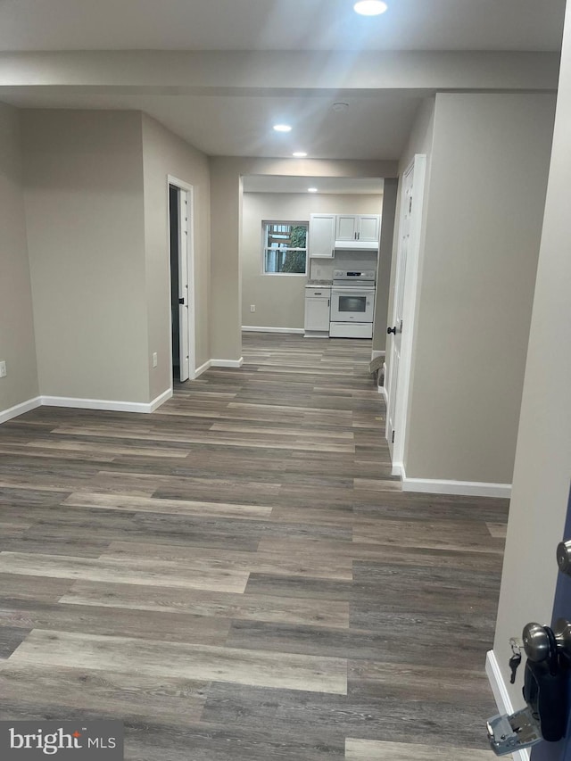 unfurnished living room with dark wood-type flooring