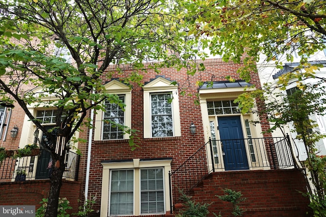 view of side of property featuring a balcony