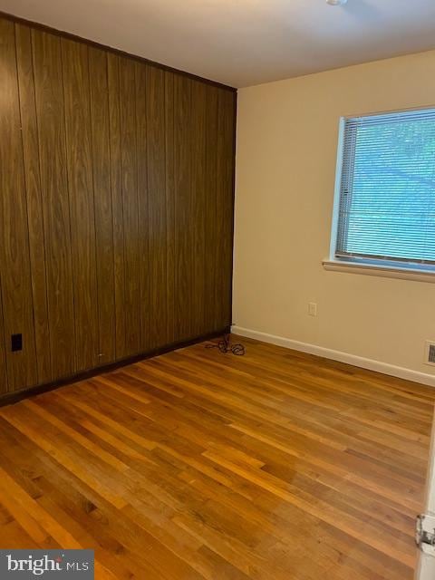 unfurnished room with wood-type flooring