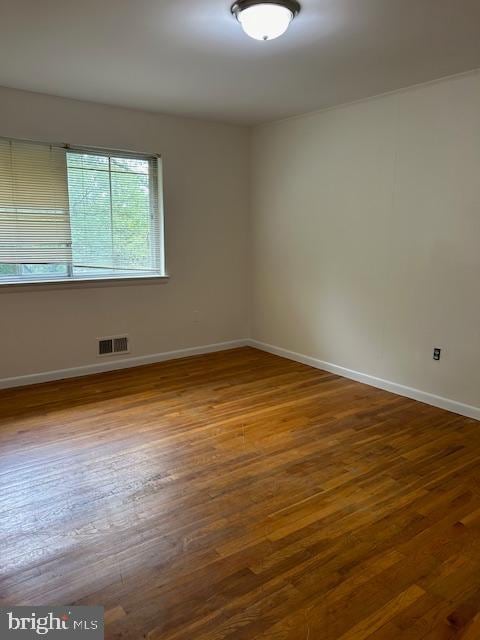 unfurnished room featuring hardwood / wood-style floors