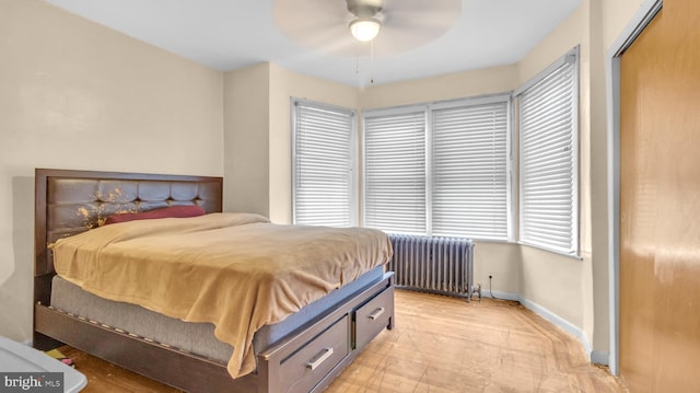 bedroom featuring radiator, ceiling fan, and a closet