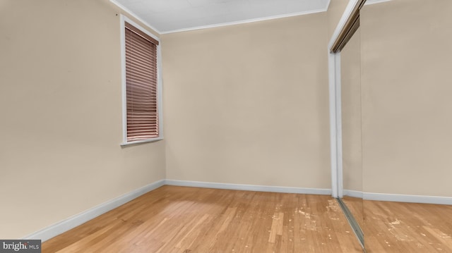 interior space with crown molding and light hardwood / wood-style floors