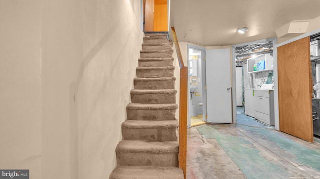 stairs featuring washer / clothes dryer