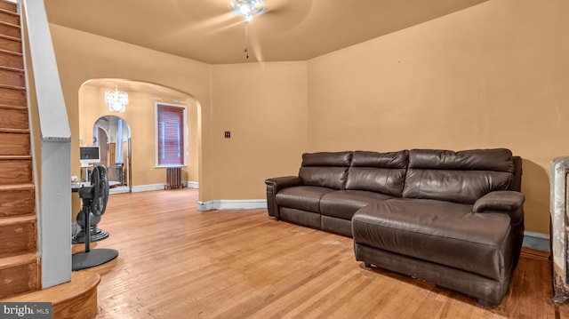 living room featuring ceiling fan, light hardwood / wood-style floors, and radiator heating unit