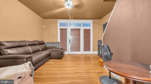 living room with light hardwood / wood-style floors and ceiling fan