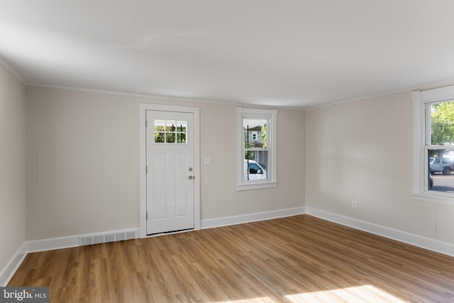 foyer featuring light hardwood / wood-style flooring and ornamental molding