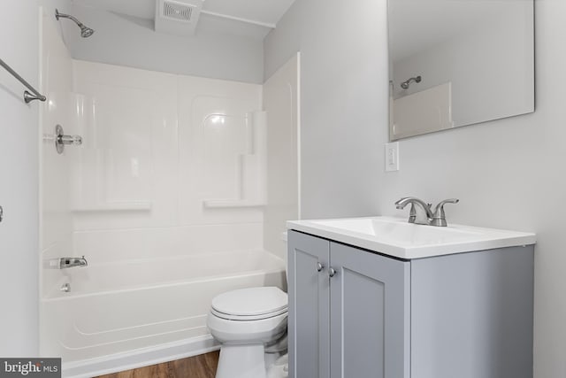 full bathroom with tub / shower combination, vanity, toilet, and hardwood / wood-style floors