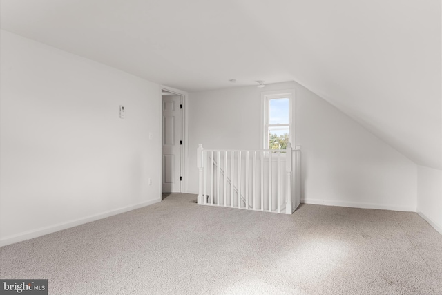 bonus room with carpet floors and vaulted ceiling