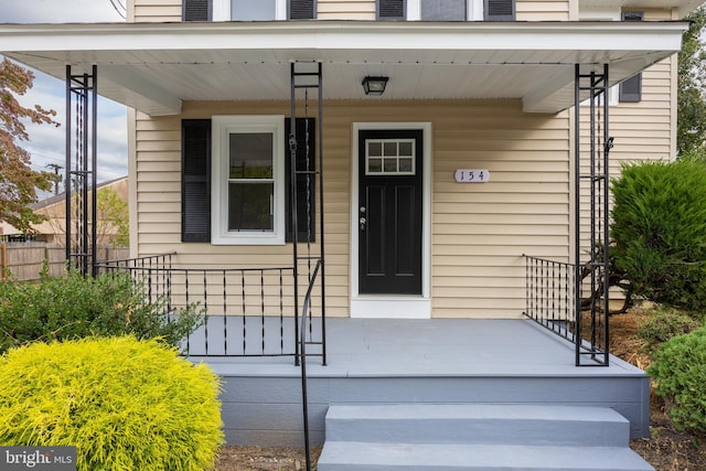 view of exterior entry featuring a porch