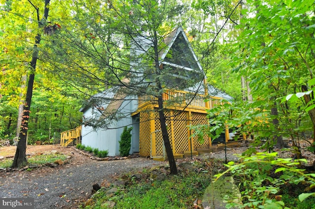 view of home's exterior with a wooden deck