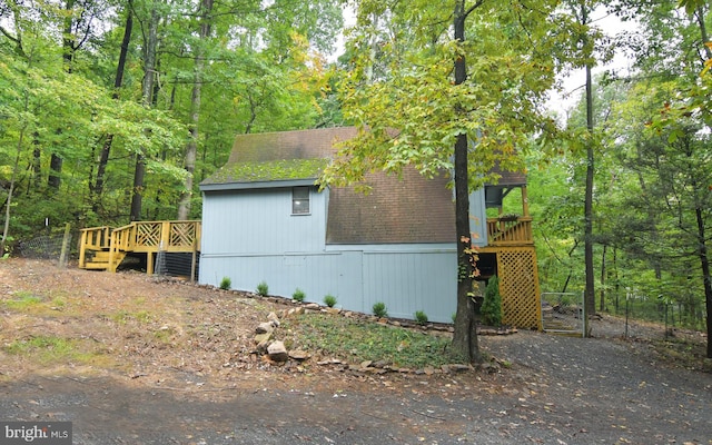 view of property exterior with a wooden deck