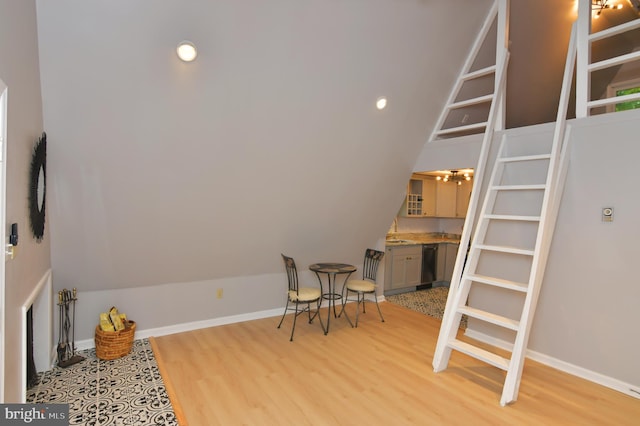 interior space with lofted ceiling and light hardwood / wood-style flooring