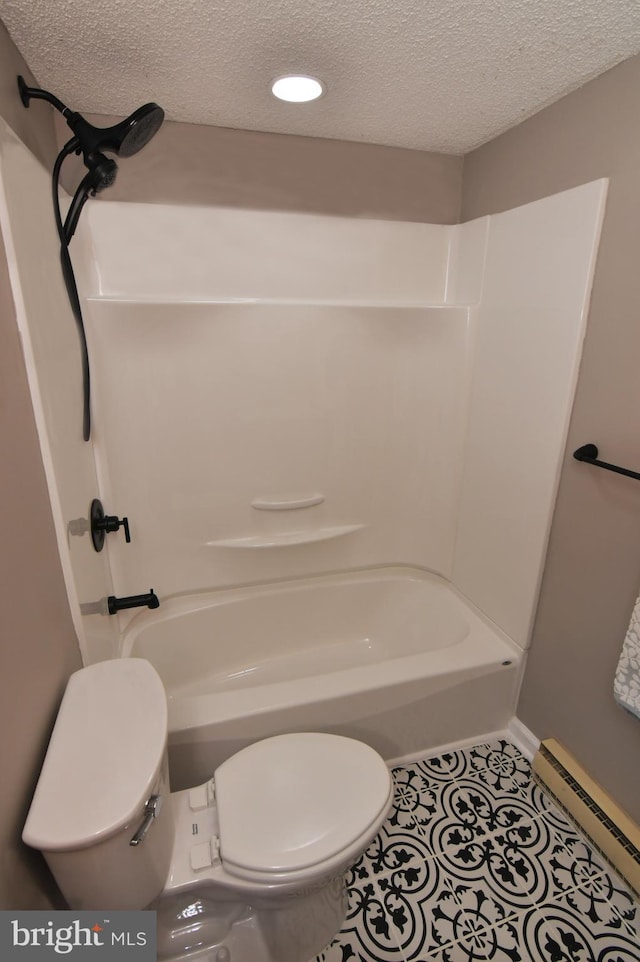 bathroom featuring toilet, a textured ceiling, shower / washtub combination, and a baseboard radiator