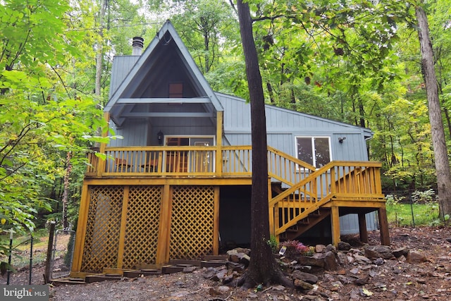 rear view of property featuring a wooden deck