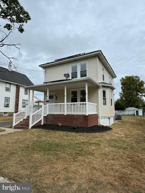 view of front facade with covered porch and a front lawn