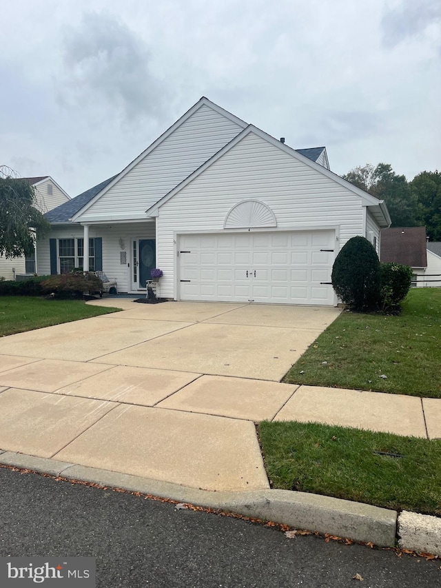 view of front of house featuring a garage and a front lawn