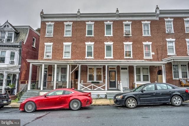 townhome / multi-family property with a porch