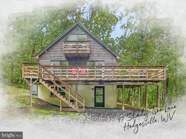 back of house featuring stairway and a wooden deck