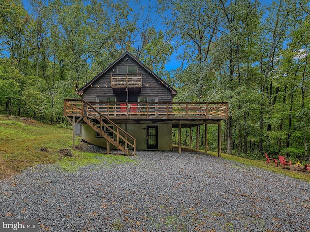 chalet / cabin with stairs and a wooden deck