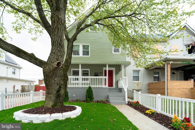 view of front of house with a front lawn and a porch