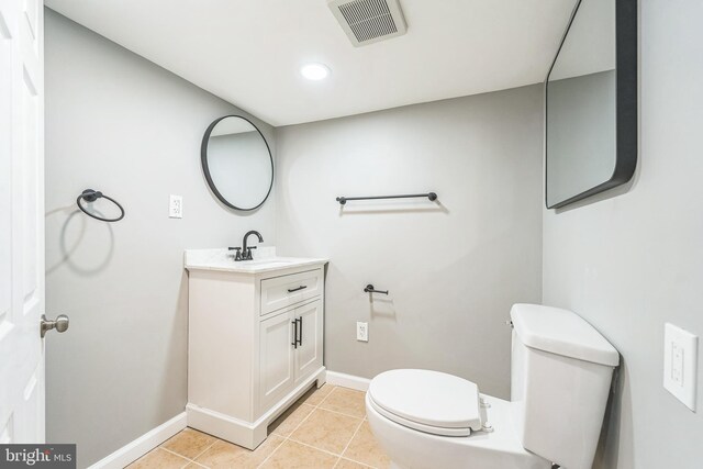 bathroom with tile patterned floors, vanity, and toilet