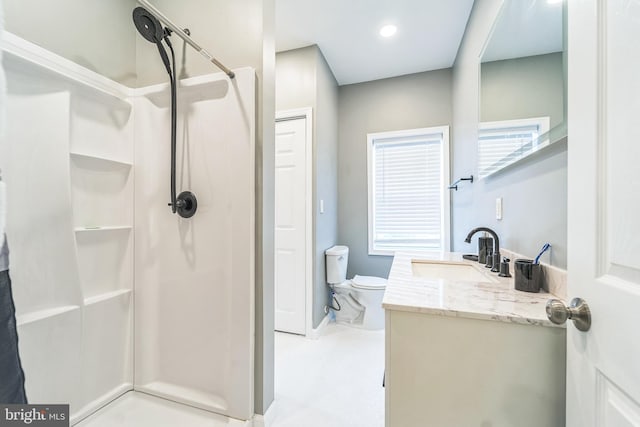 bathroom featuring walk in shower, vanity, and toilet