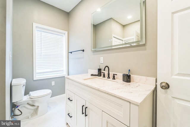 bathroom featuring vanity and toilet