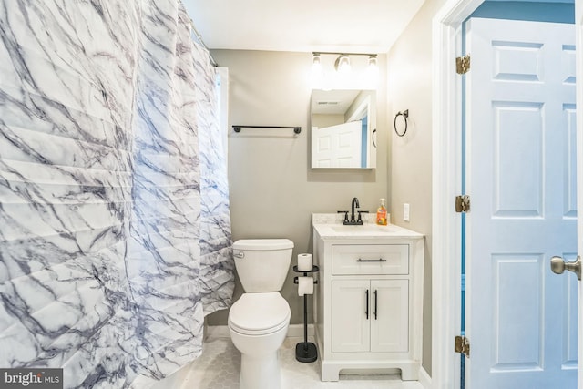 bathroom with walk in shower, vanity, and toilet