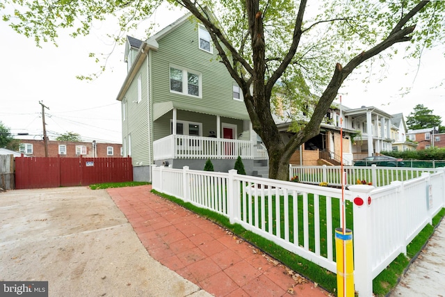 view of front of house with a porch and a front lawn