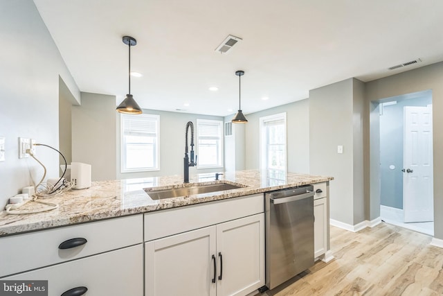 kitchen featuring dishwasher, sink, white cabinets, light hardwood / wood-style flooring, and light stone countertops