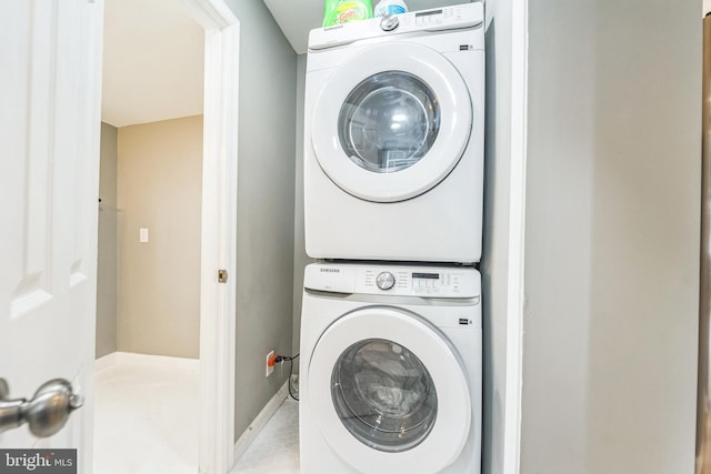 washroom featuring stacked washer / dryer