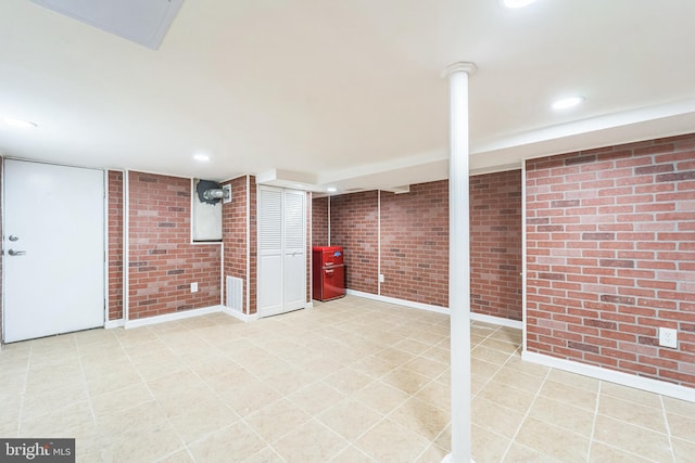 basement with brick wall