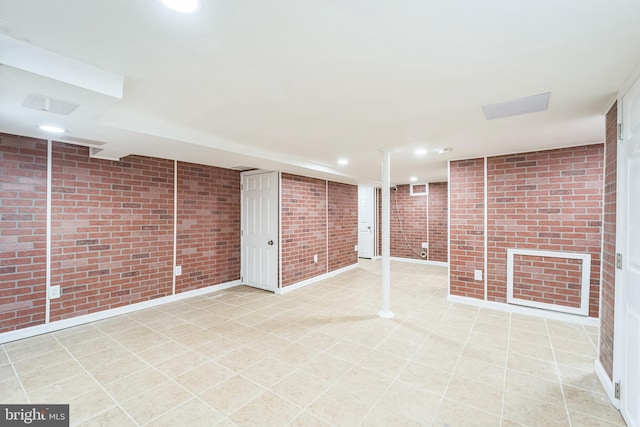 basement featuring brick wall