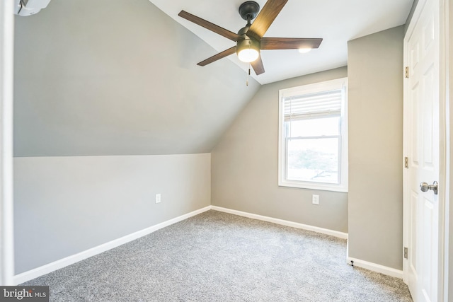 additional living space featuring vaulted ceiling, light carpet, and ceiling fan