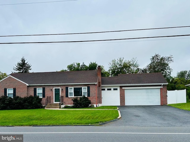 view of front of house with a garage and a front yard