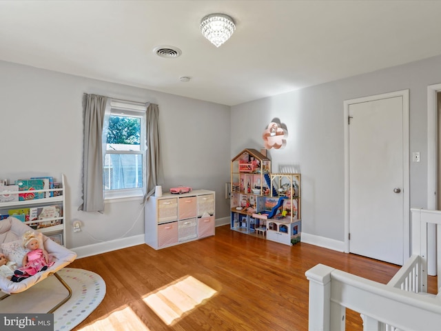 rec room with hardwood / wood-style floors