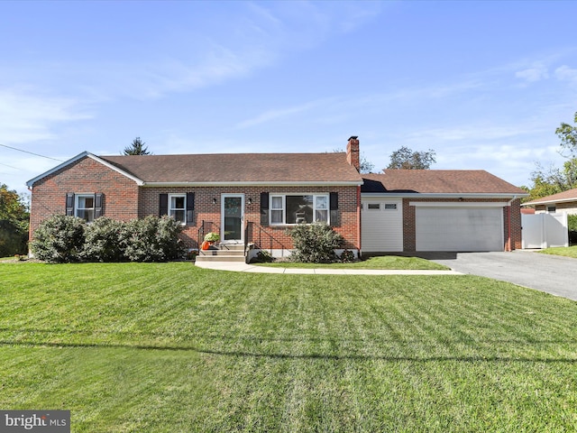 ranch-style home featuring a front yard and a garage