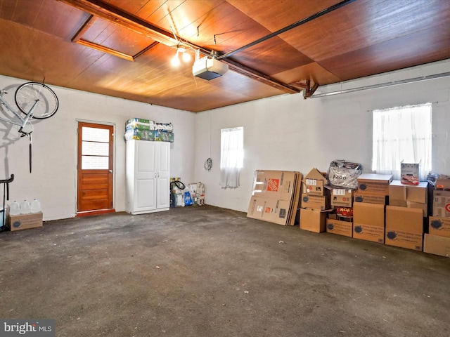 garage featuring a garage door opener and wood ceiling