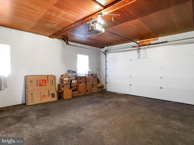 garage with a garage door opener and wooden ceiling