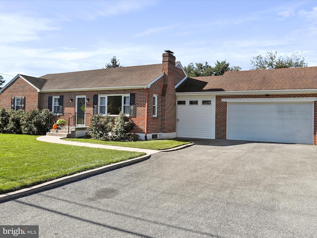 ranch-style house featuring a front yard and a garage