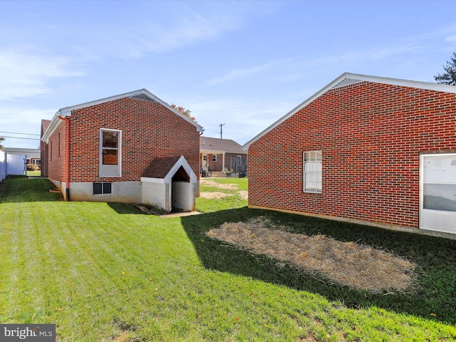 view of side of home featuring a lawn