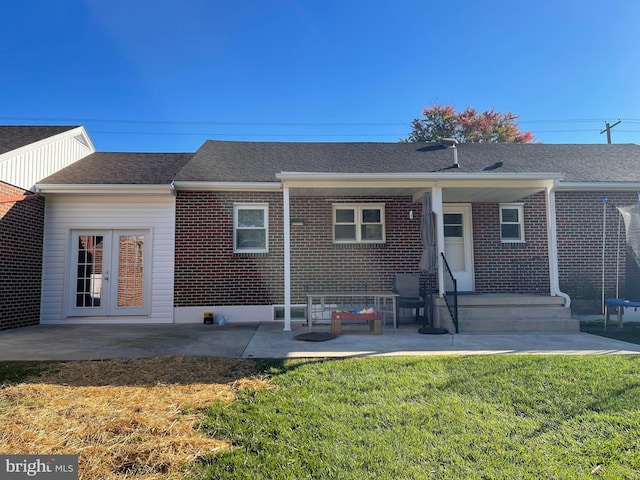 back of house featuring a lawn and a patio area